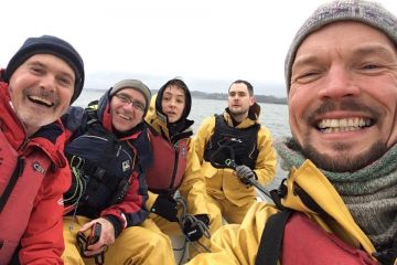 sailors smiling on a keelboat