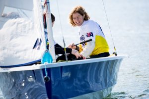 Woman sailing a dinghy for the first time and loving it